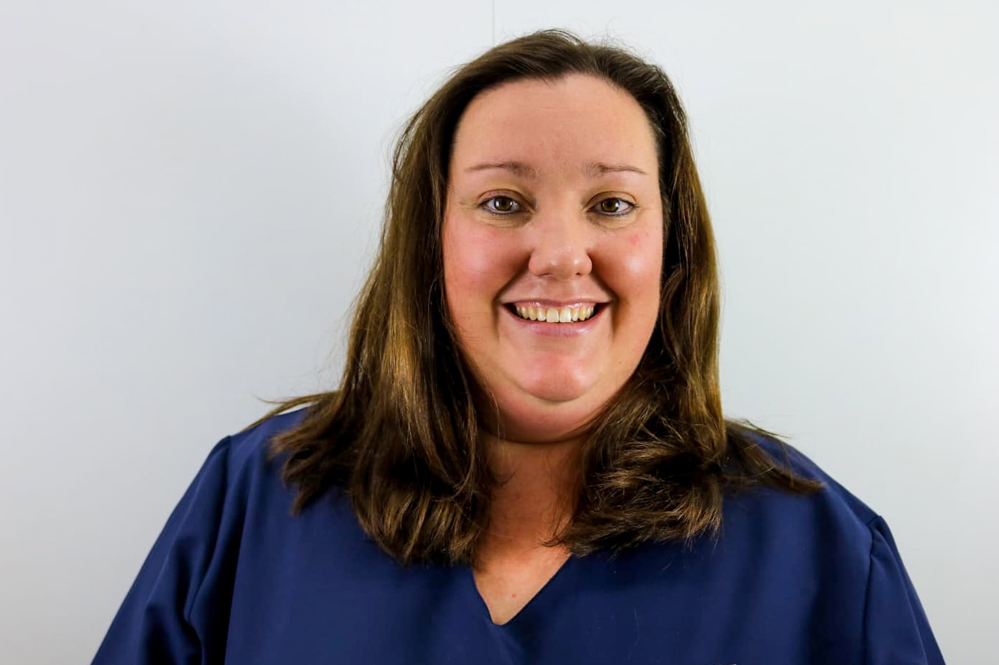 Team member smiling in professional attire at Spliff Nation Dispensary.